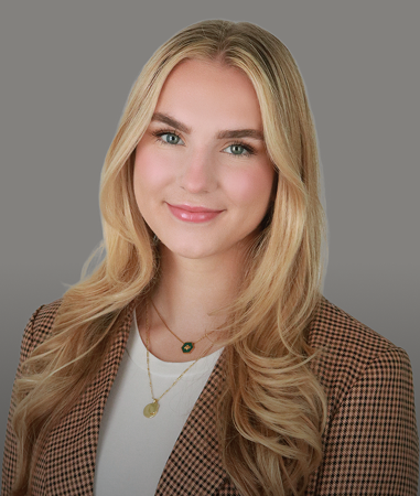 Professional LinkedIn headshot, tweed blazer, neutral backdrop.